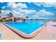 Large community pool with clear blue water surrounded by lounge chairs and ample deck space, perfect for relaxation at 458 Meadowood Blvd, Fern Park, FL 32730