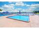 Leisure pool offering a refreshing escape with poolside seating, set against a sunny lakeside backdrop at 458 Meadowood Blvd, Fern Park, FL 32730