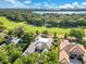 Stunning aerial view of the property, lush landscaping, with lake and golf course in the background at 5157 Latrobe Dr, Windermere, FL 34786