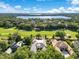 Gorgeous aerial showcasing the home's expansive surroundings, beautiful golf course and lake views at 5157 Latrobe Dr, Windermere, FL 34786