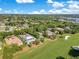 Aerial view showing location surrounded by trees, golf course, a lake and residential area with pools at 5157 Latrobe Dr, Windermere, FL 34786