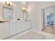 Bright bathroom featuring a double vanity with marble counters and decorative tile flooring at 5157 Latrobe Dr, Windermere, FL 34786