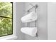 Bathroom featuring wall mounted towel rack next to a window with view of backyard at 5157 Latrobe Dr, Windermere, FL 34786