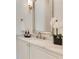 Bathroom featuring a marble countertop, decorative mirror, and sleek modern faucet at 5157 Latrobe Dr, Windermere, FL 34786