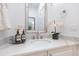 Bathroom vanity with marble countertop, vessel sink, framed mirror, and decorative accents at 5157 Latrobe Dr, Windermere, FL 34786