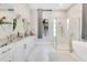 Bathroom featuring dual vanity, soaking tub, and glass-enclosed shower at 5157 Latrobe Dr, Windermere, FL 34786