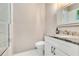Bright bathroom featuring a white vanity with granite counters, toilet, and tiled shower with glass doors at 5157 Latrobe Dr, Windermere, FL 34786