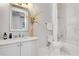 Bright bathroom featuring a white vanity with marble counters, toilet, and tiled shower at 5157 Latrobe Dr, Windermere, FL 34786