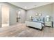 Bedroom with rustic wood floors, nightstands, and a view to the walk-in closet and bathroom at 5157 Latrobe Dr, Windermere, FL 34786
