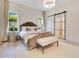 Luxurious bedroom featuring a tufted headboard, chandelier, and sliding glass door to the bathroom at 5157 Latrobe Dr, Windermere, FL 34786