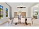 Stylish dining room with large wood table, modern chandelier, and light gray walls at 5157 Latrobe Dr, Windermere, FL 34786