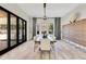 Formal dining room with wooden table, stylish lighting, and sliding doors leading to the outdoor space at 5157 Latrobe Dr, Windermere, FL 34786