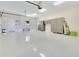 A well-lit garage features storage cabinets, bright epoxy floors and work bench at 5157 Latrobe Dr, Windermere, FL 34786