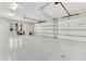 Spacious three-car garage featuring epoxy flooring and ample space for storage at 5157 Latrobe Dr, Windermere, FL 34786