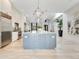 Open kitchen with island, marble counters, stainless appliances, and designer lighting at 5157 Latrobe Dr, Windermere, FL 34786