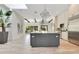 Modern kitchen with gray island, stainless steel appliances, and overhead lights at 5157 Latrobe Dr, Windermere, FL 34786