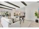 Open concept living room flows to the kitchen with beams and bright modern decor at 5157 Latrobe Dr, Windermere, FL 34786