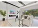 Comfortable living room featuring a modern fireplace, TV, and views of the backyard and pool area at 5157 Latrobe Dr, Windermere, FL 34786