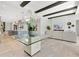 Open concept living space with beams, modern decor, and seamless flow to the kitchen at 5157 Latrobe Dr, Windermere, FL 34786