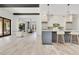 Elegant open-concept design featuring dark-stained ceiling beams and a kitchen island with bar seating at 5157 Latrobe Dr, Windermere, FL 34786