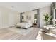 Bright main bedroom features a plush bed, sitting area, and light wood floors at 5157 Latrobe Dr, Windermere, FL 34786
