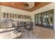 Stylish outdoor kitchen with stainless steel appliances, custom shelving, and comfortable seating area at 5157 Latrobe Dr, Windermere, FL 34786