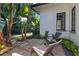 Outdoor patio with tropical landscaping and comfortable wicker chairs for outdoor entertaining at 5157 Latrobe Dr, Windermere, FL 34786