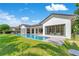 A beautiful backyard, pool, and outdoor living space with a modern white home and expansive windows at 5157 Latrobe Dr, Windermere, FL 34786