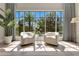 Relaxing sitting area with pool view, neutral tones, and natural light at 5157 Latrobe Dr, Windermere, FL 34786