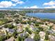 An aerial view shows homes and lush landscaping along the lake in a desirable lakeside community at 5335 Bay Side Dr, Orlando, FL 32819