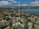 Gorgeous aerial view of the property showcasing its location and surrounding community with a large lake at 5335 Bay Side Dr, Orlando, FL 32819