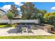 Inviting backyard space features a brick patio, fire pit, and comfortable seating area at 5335 Bay Side Dr, Orlando, FL 32819