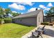 Nicely landscaped backyard with patio, seating area, and view of the home's exterior at 5335 Bay Side Dr, Orlando, FL 32819