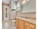 Well-lit bathroom with a walk-in shower, granite counters, and tile floors at 5335 Bay Side Dr, Orlando, FL 32819