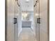 Hallway view into a modern bathroom with double sinks and a glass enclosed shower at 5335 Bay Side Dr, Orlando, FL 32819