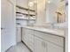 Well-lit bathroom with granite countertops, double vanity, and plentiful storage space at 5335 Bay Side Dr, Orlando, FL 32819