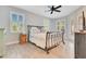 Bright bedroom with a metal-framed bed, neutral-toned bedding, and natural light from multiple windows at 5335 Bay Side Dr, Orlando, FL 32819