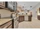Spacious kitchen features sleek appliances, granite countertops, dark cabinetry, and an open design at 5335 Bay Side Dr, Orlando, FL 32819