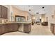 Open kitchen view into spacious living room with fireplace, TV, tile flooring, and lanai access at 5335 Bay Side Dr, Orlando, FL 32819