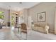 Sunlit seating area showcases elegant furnishings, a decorative painting, and access to the outside at 5335 Bay Side Dr, Orlando, FL 32819