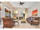 Comfortable living room with fireplace, TV, tile flooring, and view of the lanai at 5335 Bay Side Dr, Orlando, FL 32819