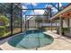 Inviting in-ground pool area featuring a waterfall, screened enclosure, and patio at 5335 Bay Side Dr, Orlando, FL 32819