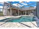 A lovely screened-in pool with patio and outdoor seating for backyard entertaining at 5335 Bay Side Dr, Orlando, FL 32819