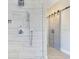 Sleek shower design featuring elegant marble tiling and a glass door with modern hardware at 5335 Bay Side Dr, Orlando, FL 32819