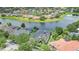 Aerial view of a home on a waterfront lot, surrounded by lush greenery and neighboring houses at 5944 Lake Melrose Dr, Orlando, FL 32829