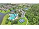 Aerial view showcases a community with pools, tennis courts, pickleball courts, and surrounding landscaping at 5944 Lake Melrose Dr, Orlando, FL 32829