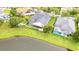 An aerial view of a beautiful home with a screened-in pool and a scenic lakefront backyard at 5944 Lake Melrose Dr, Orlando, FL 32829