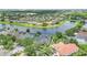 Aerial shot of a home's fenced-in yard, pool, screened-in patio, and beautiful landscaping near a lake at 5944 Lake Melrose Dr, Orlando, FL 32829