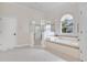 Bright bathroom with soaking tub, glass shower, and white tile at 5944 Lake Melrose Dr, Orlando, FL 32829