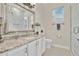 Modern bathroom features granite countertops, a decorative mirror, and a glass shower at 5944 Lake Melrose Dr, Orlando, FL 32829